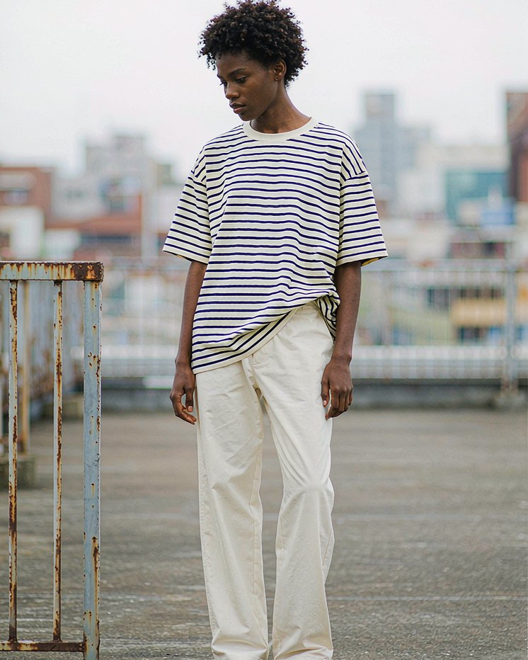 Striped Tee in Navy Ecru Stripe worn by a model